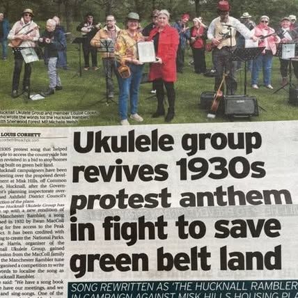 Newspaper clipping including picture of myself and others performing. In the foreground is an award being given to songwriter Louise Cooke.