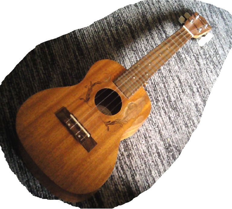 Concert uke on stripe-patterned carpet.